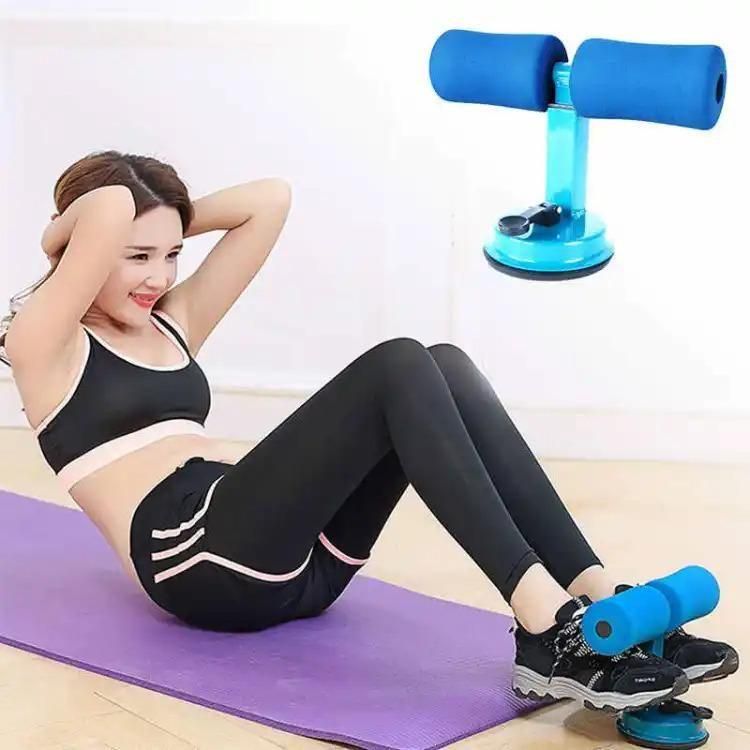 Woman using sit-up assistant bar for ab exercise on yoga mat, IndianChic fitness equipment