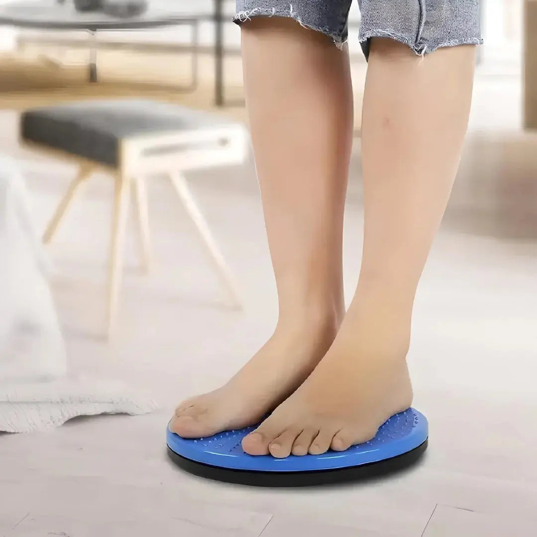 Person standing on blue tummy twister abdominal exerciser, home fitness equipment