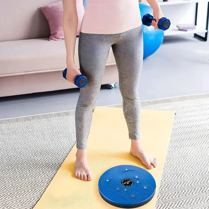 Woman on yoga mat with blue tummy twister abs exerciser and dumbbells, IndianChic fitness
